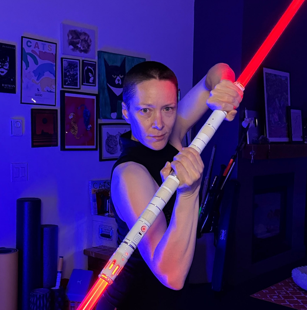 Michelle C. Smith holding her signature saber
